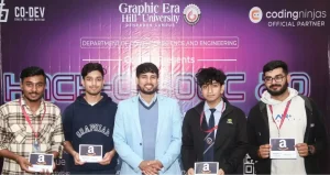 Five men pose for a group photo at a tech event in front of a purple backdrop, each holding an Amazon gift card and wearing lanyards.