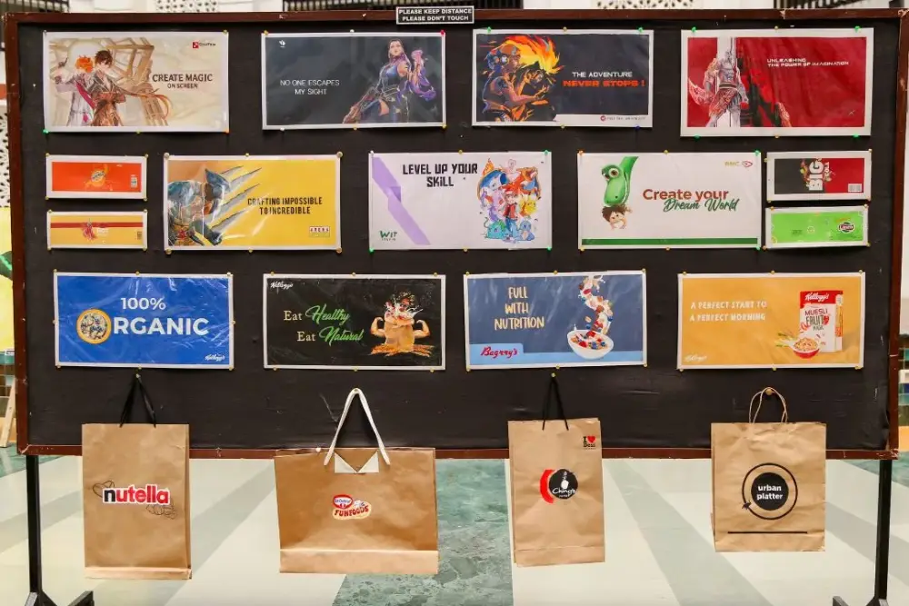 Wall display with twenty colorful banners advertising various products, with paper bags hanging beneath the board.