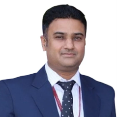 Dr. Atul Shiva Professional head-and-shoulders portrait of a man in a navy suit and tie, looking at the camera.