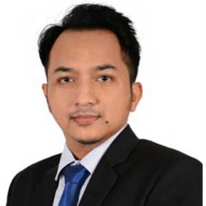 Dr. Bayu Arie Fianto Professional headshot of a man in a black suit, white shirt, and blue tie against a white background, looking at the camera with a neutral expression.