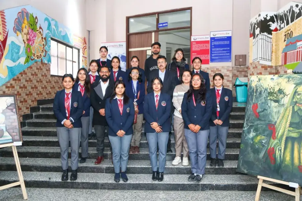 Group of students in uniform posing on a stairway with two adults in a school hallway and colorful murals behind them.